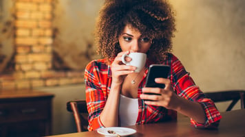 woman-sipping-coffee-on-phone